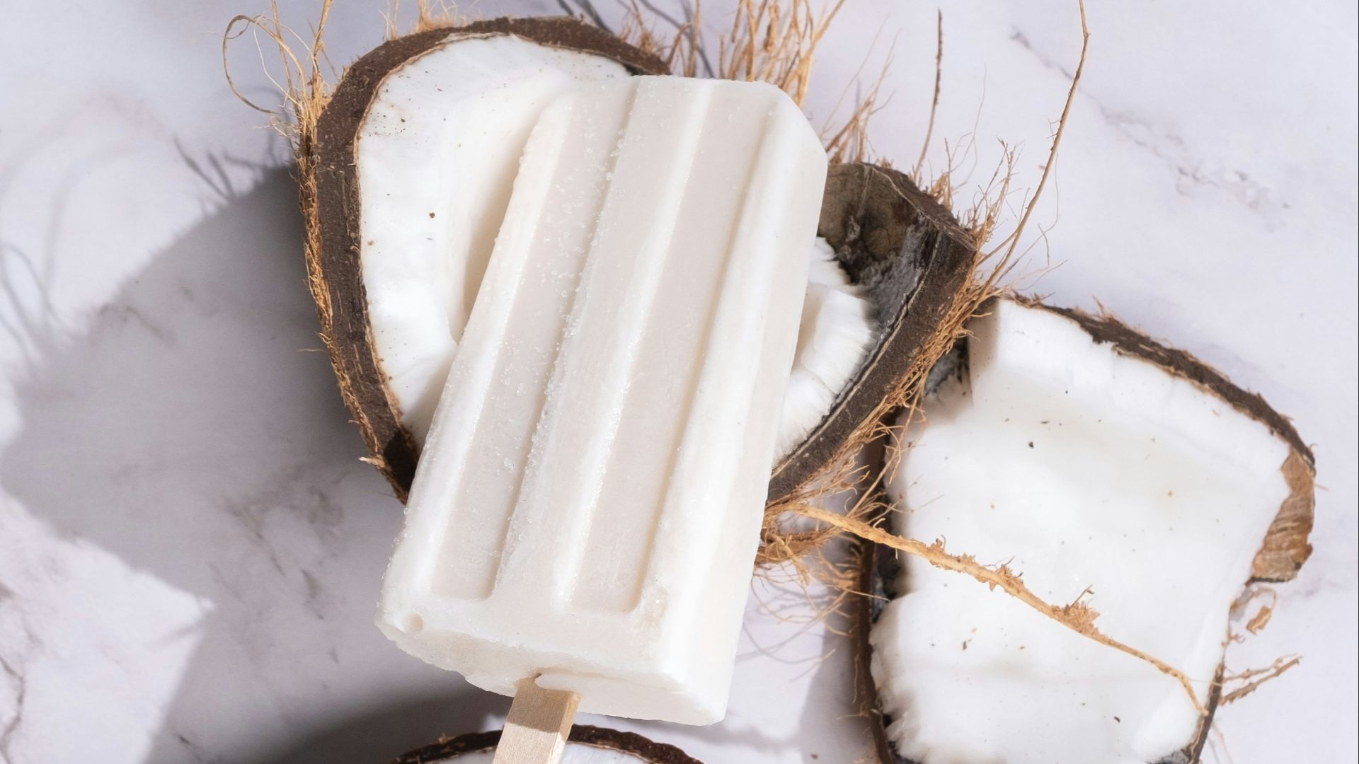 a popsicle is sitting on top of a coconut