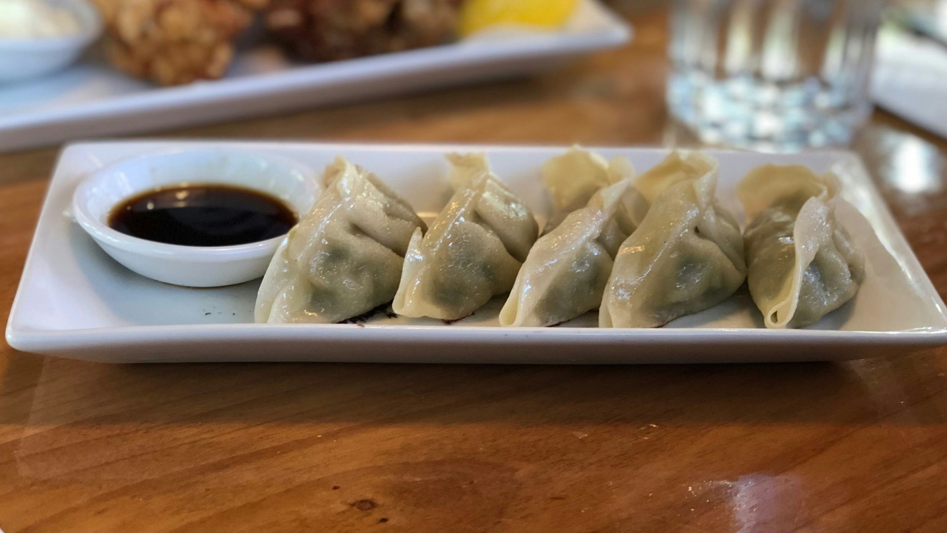 white ceramic plate on brown wooden table