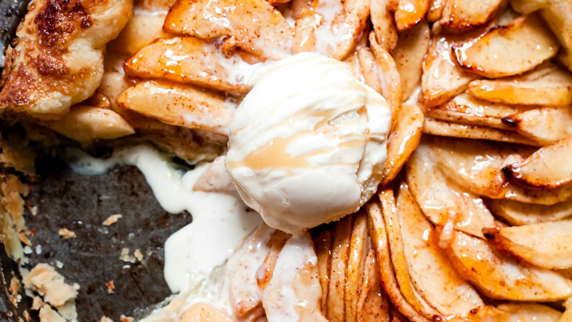 brown and white pastry on black round plate