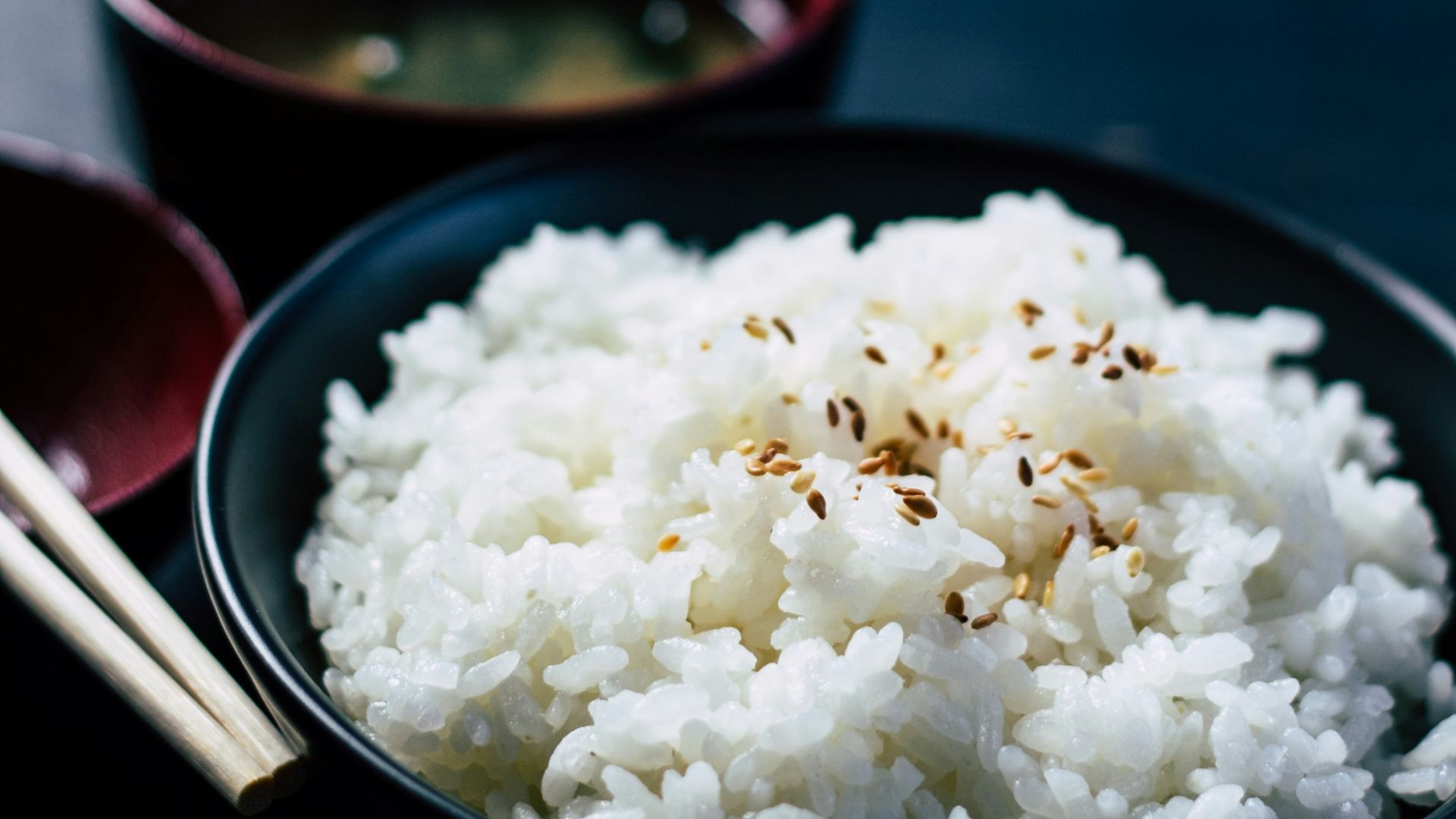 rice with sesame in black bowl
