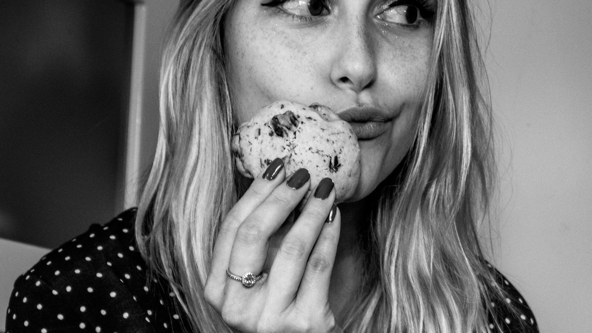 woman wearing black and white polka-dot long-sleeved shirt