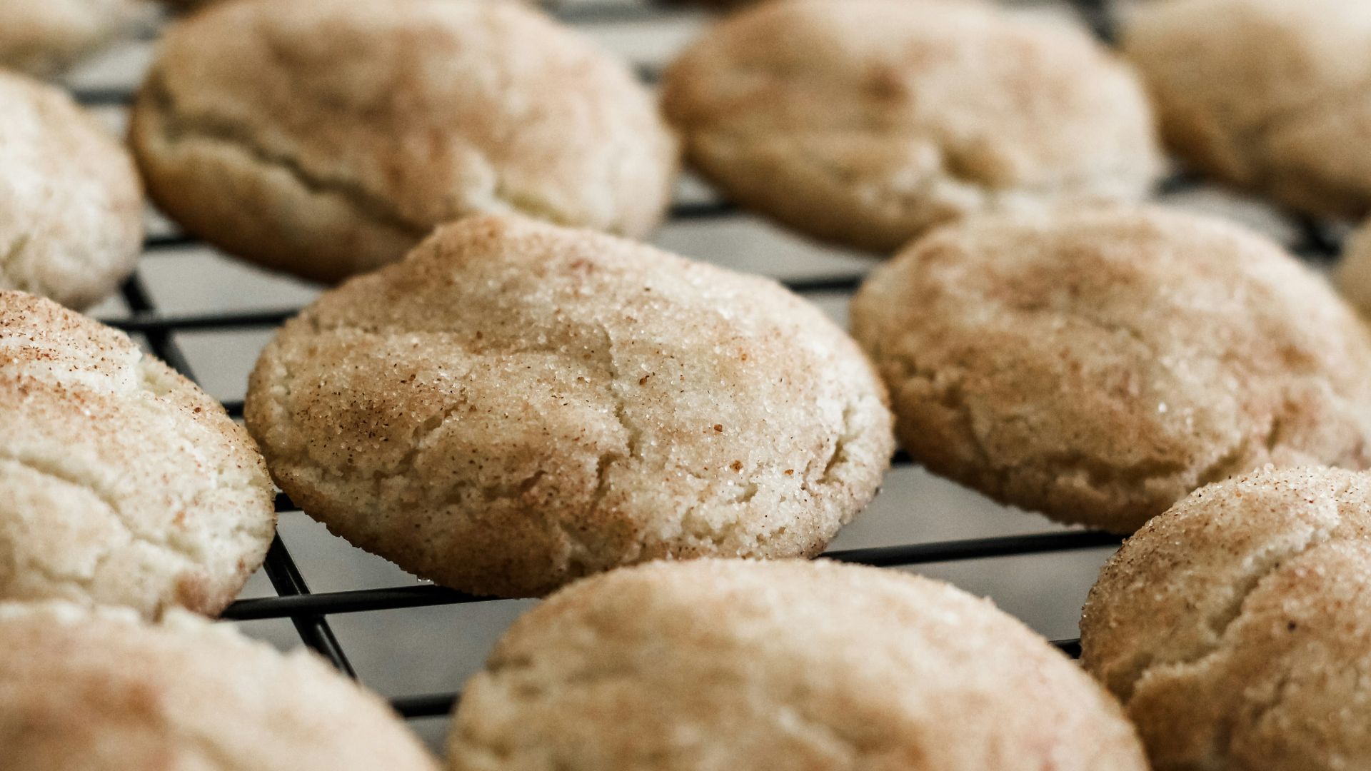 a bunch of cookies that are cooling on a rack