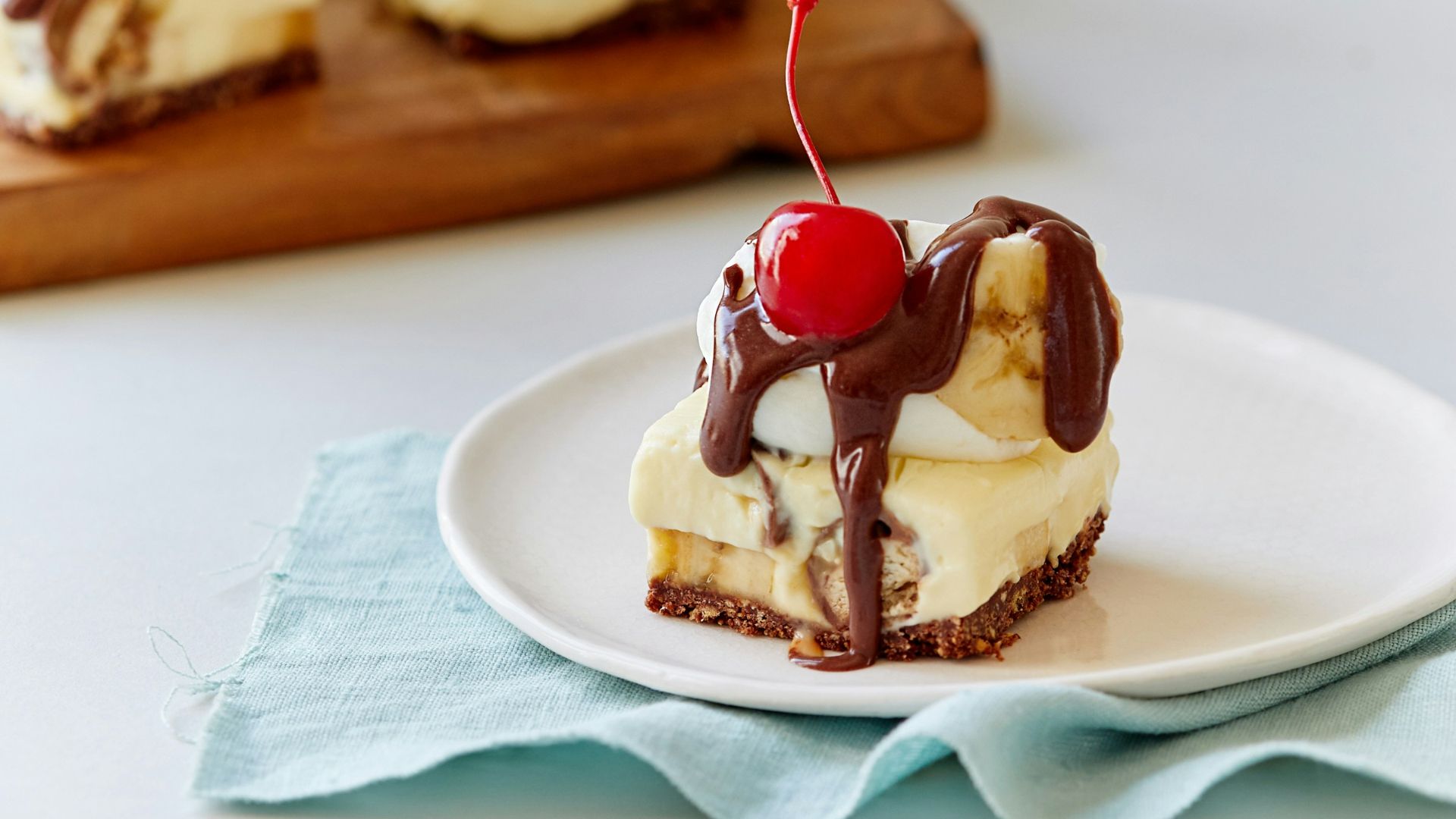 a piece of dessert on a plate with a cherry on top