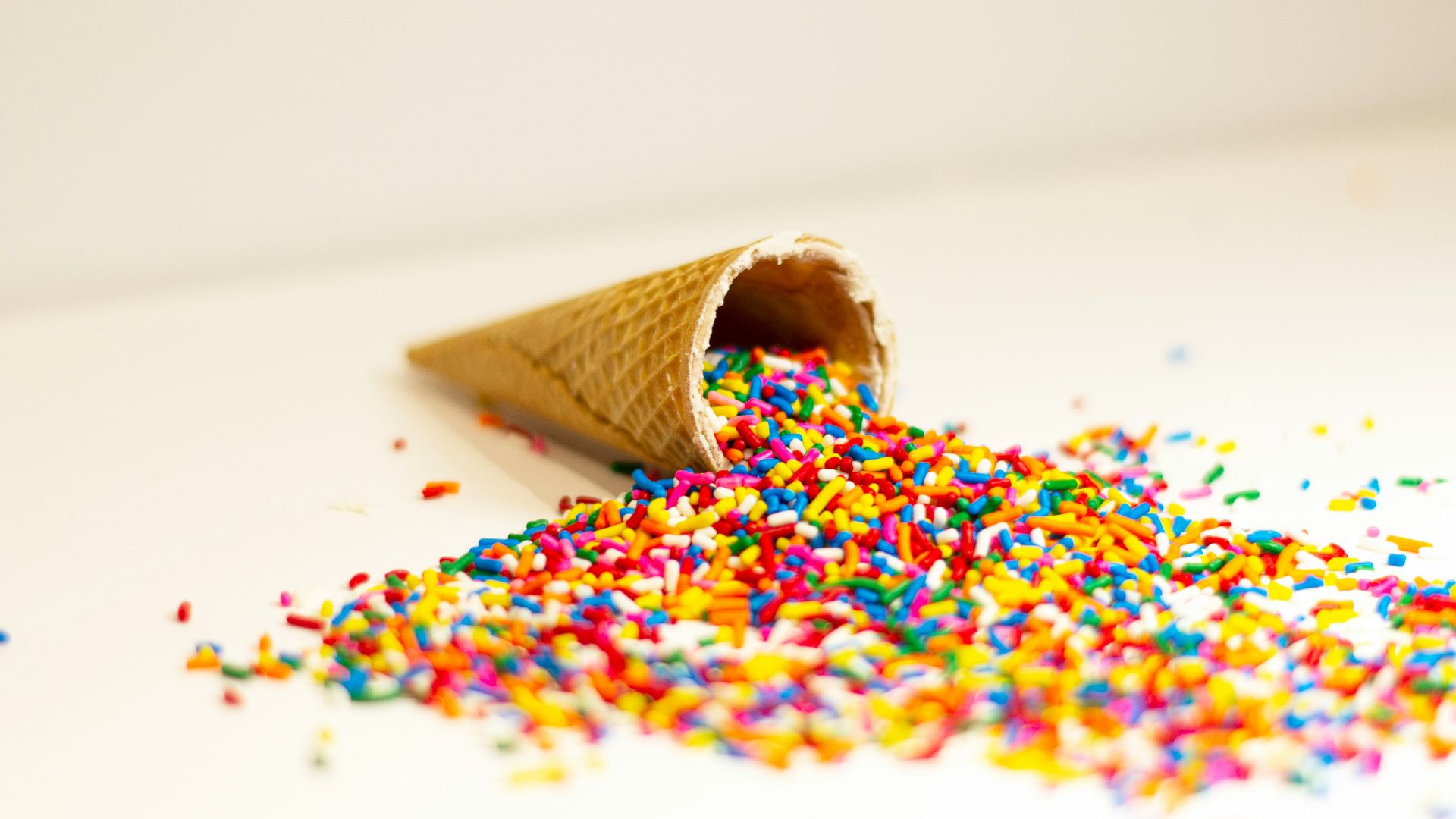 a cone filled with sprinkles on top of a table