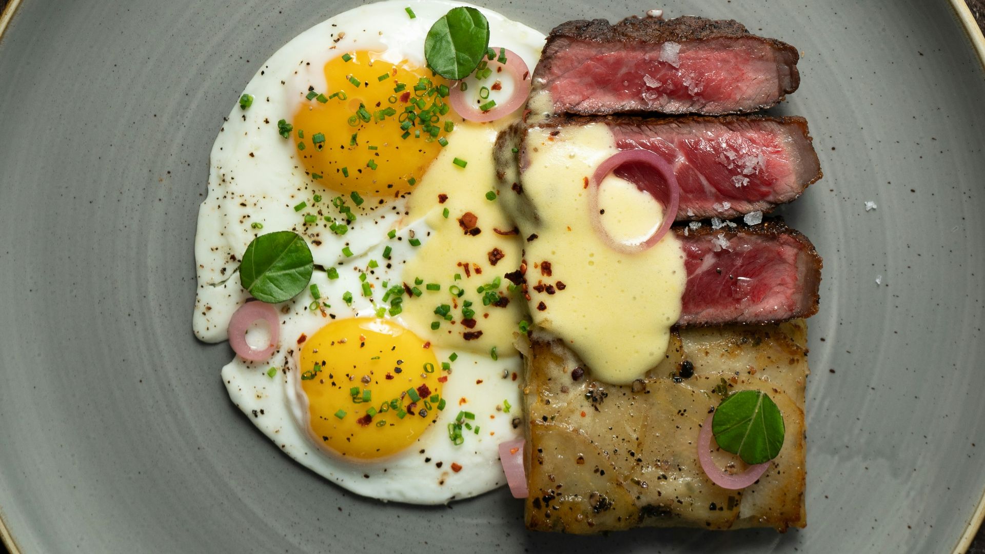 a plate of food with eggs and meat on it