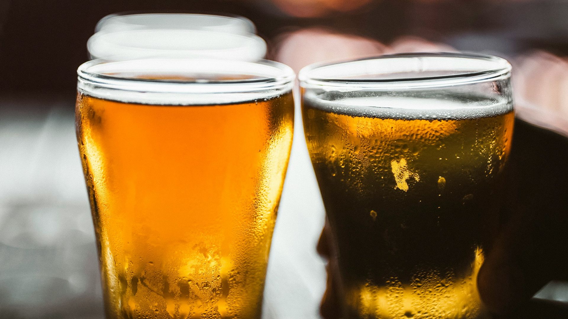 clear drinking glass with beer on black table