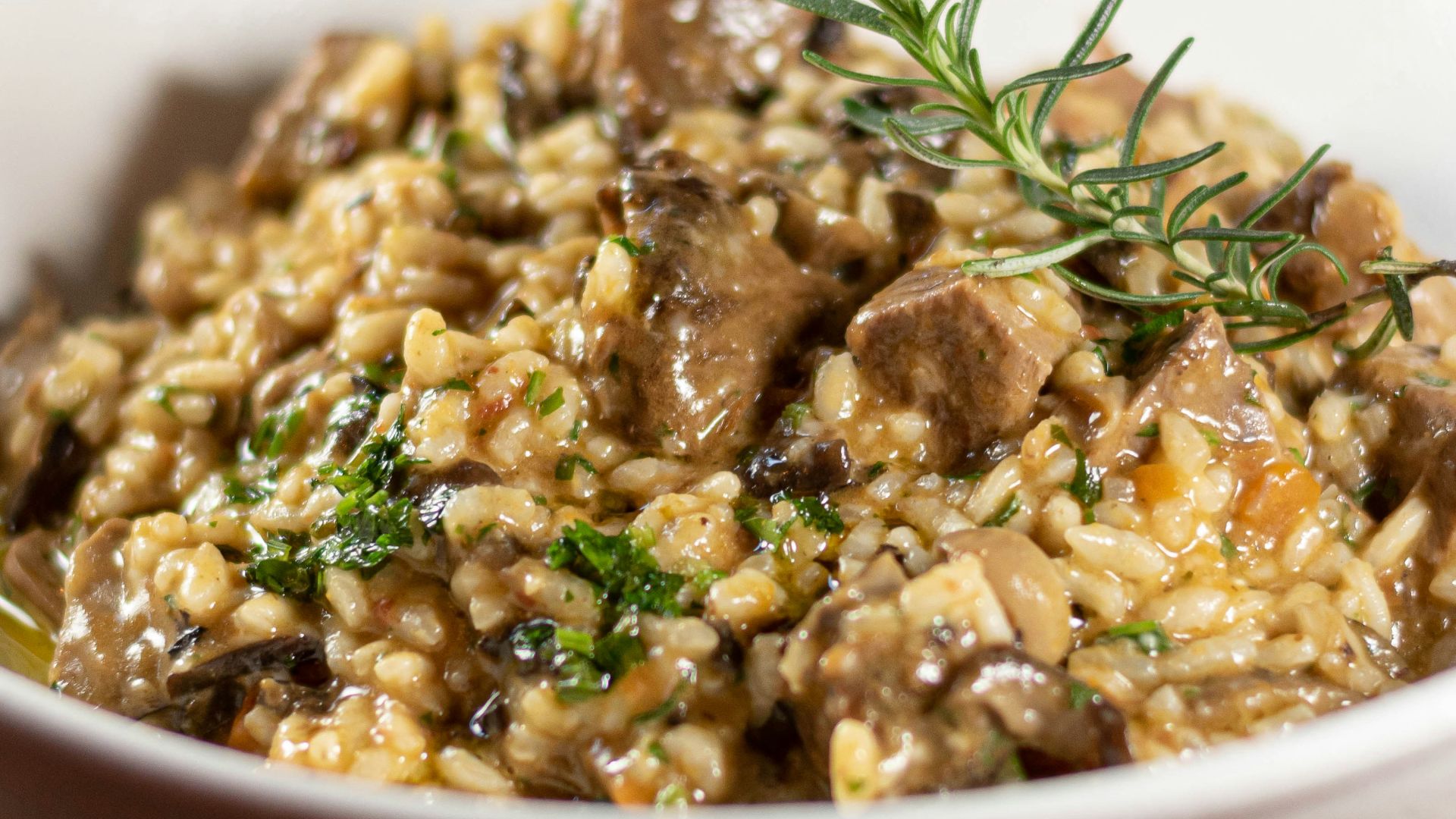 a white bowl filled with food on top of a wooden table