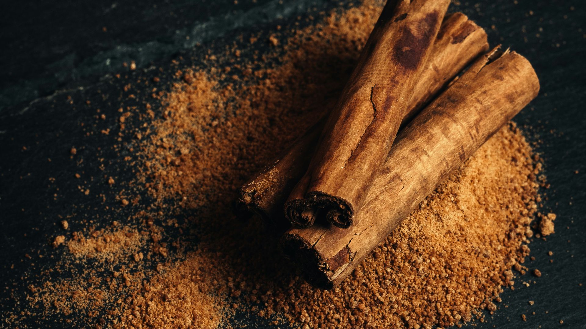 a bowl of nuts and cinnamon sticks on a table