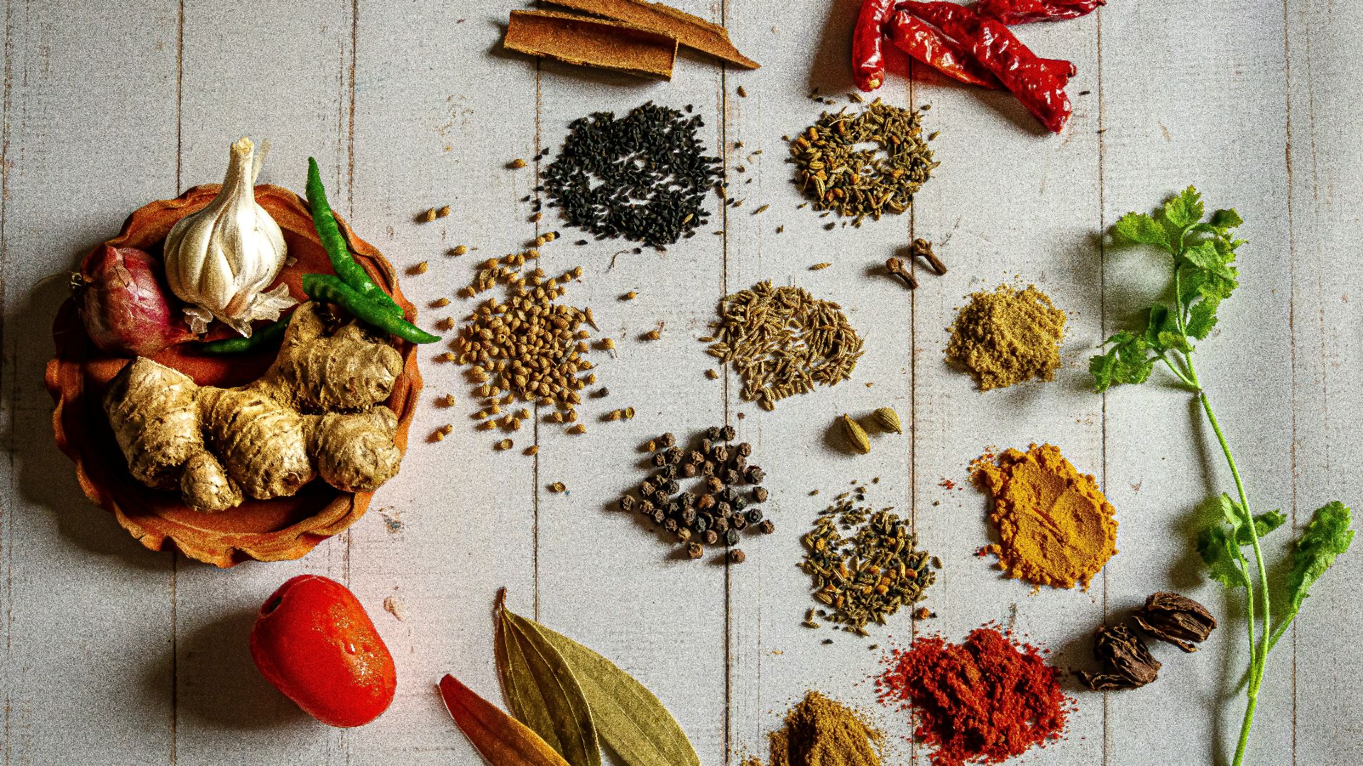 a variety of spices on a white table