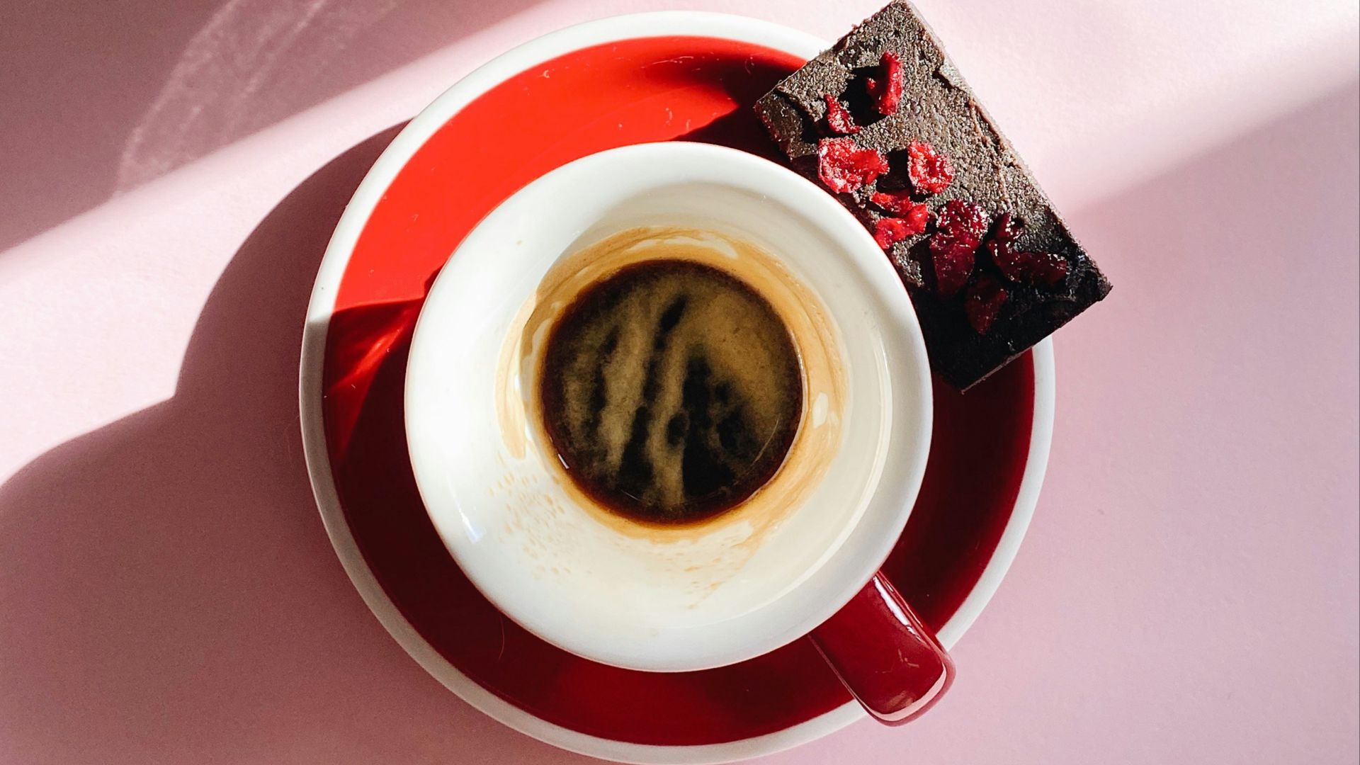 white and red ceramic mug with coffee