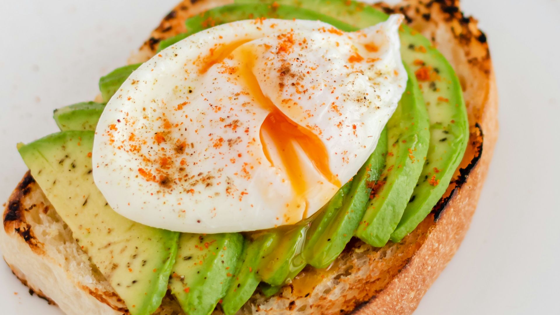 a sandwich with an egg and asparagus on it