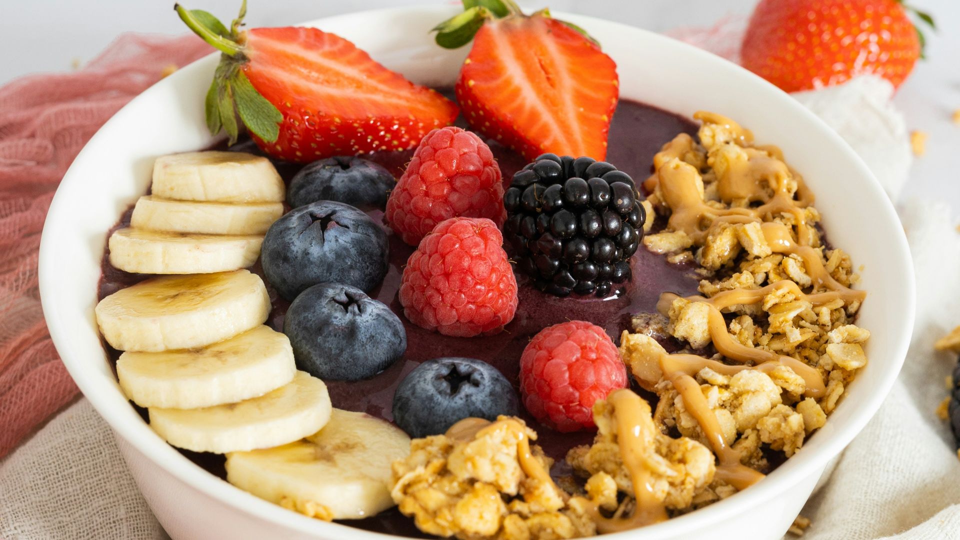 a bowl of fruit and cereal on a towel