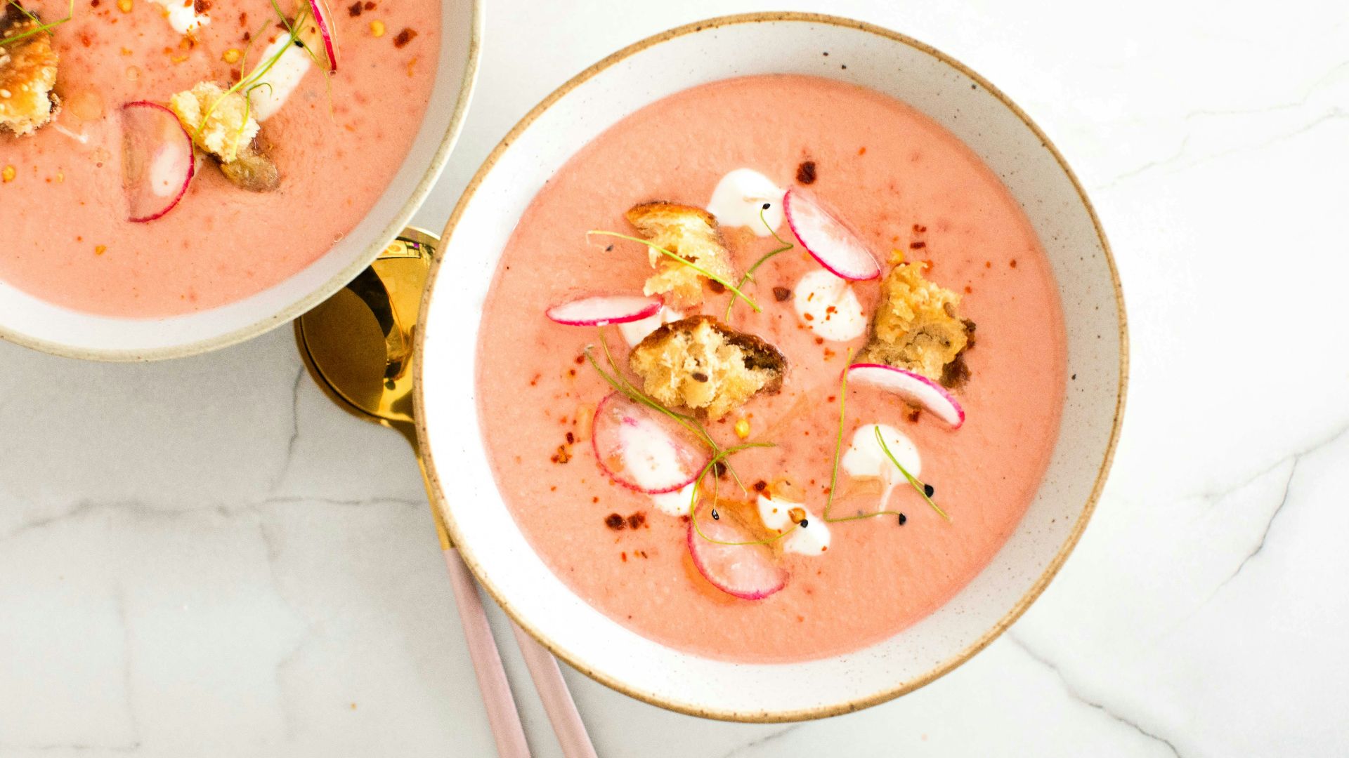 a bowl of soup with chopsticks