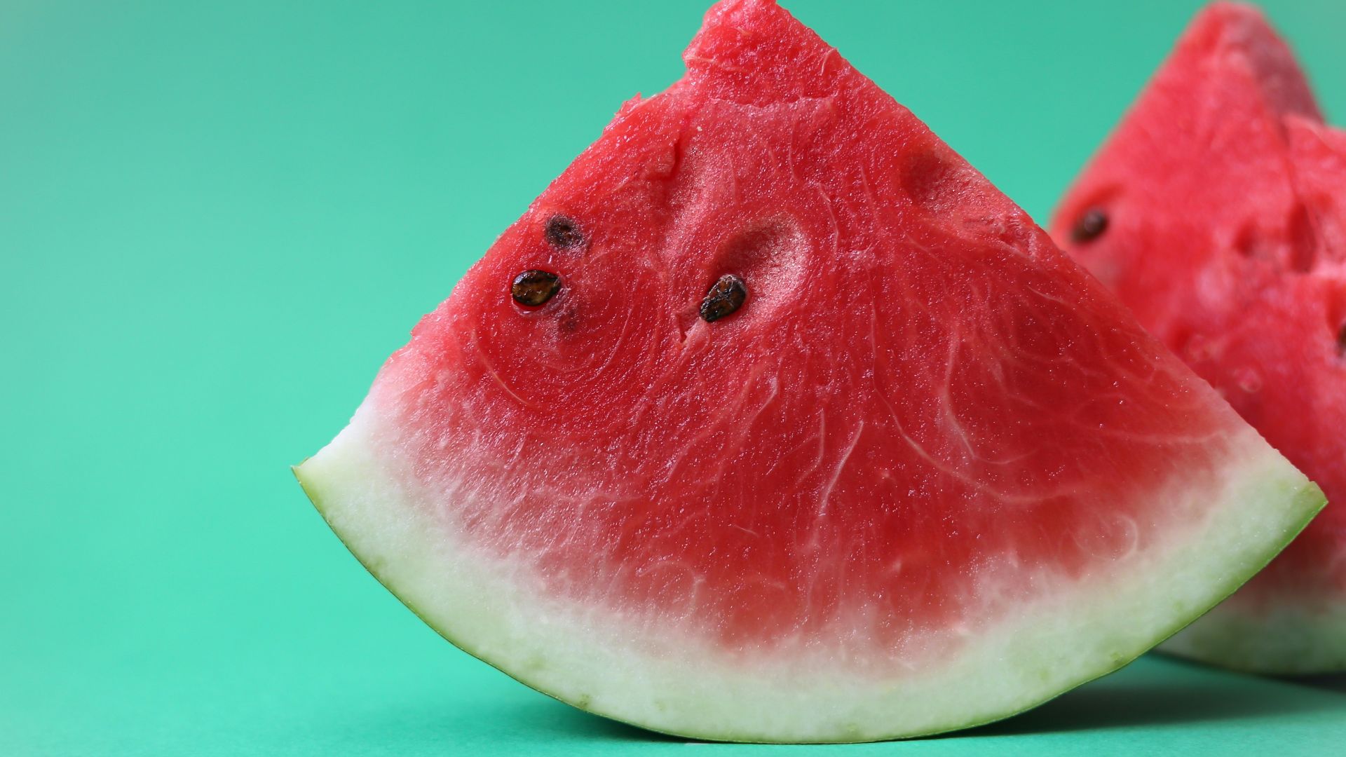 sliced watermelon on green surface