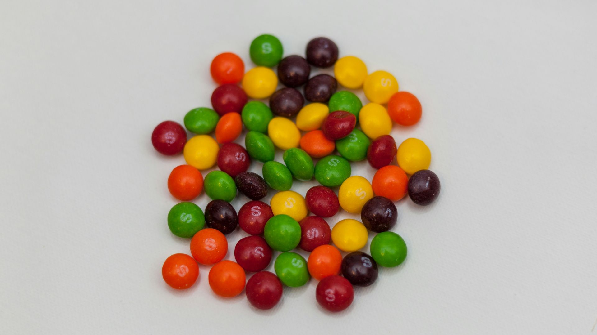 assorted-color chocolates on white surface