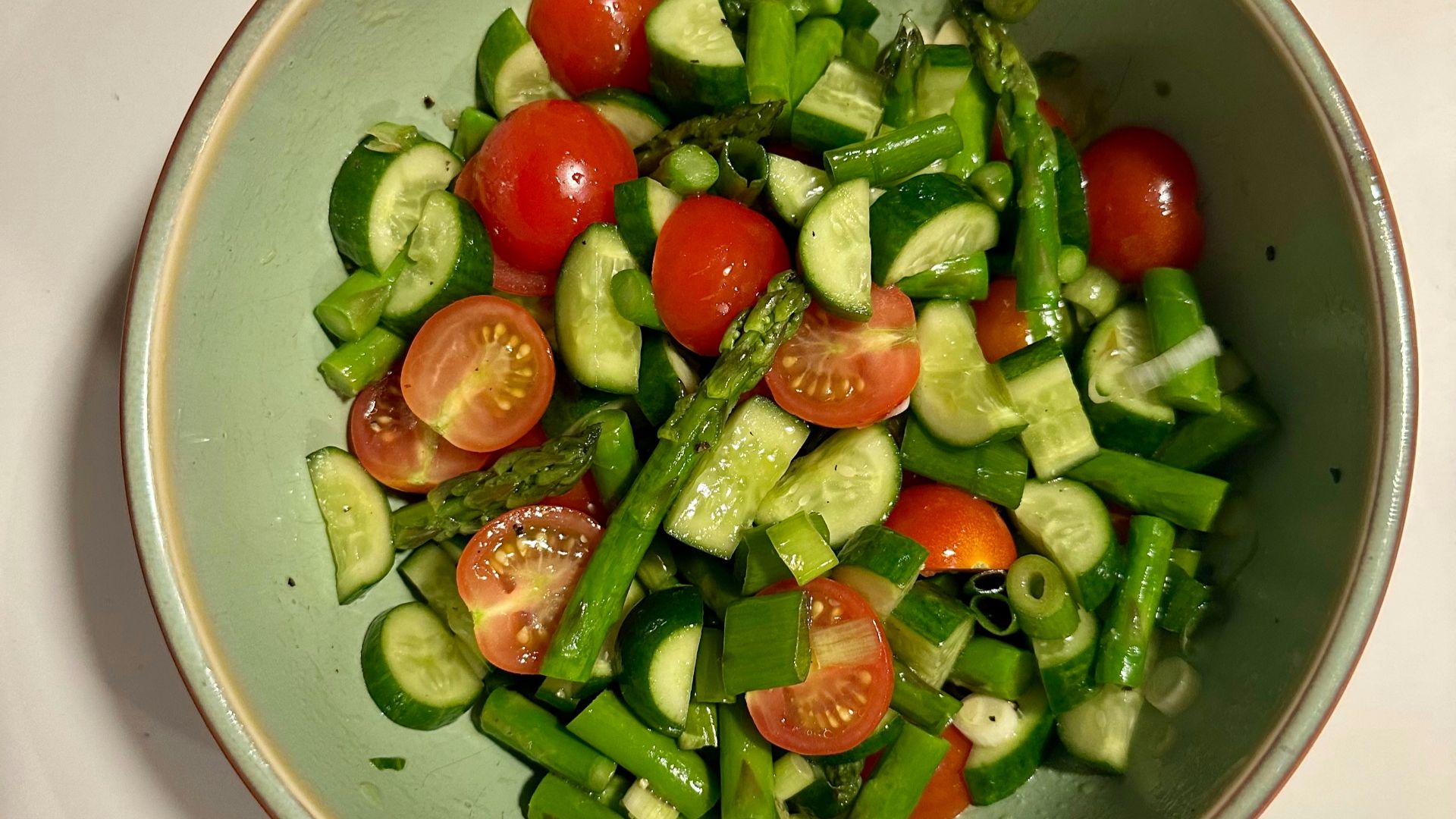 Fresh salad with tomatoes, cucumber, and asparagus.