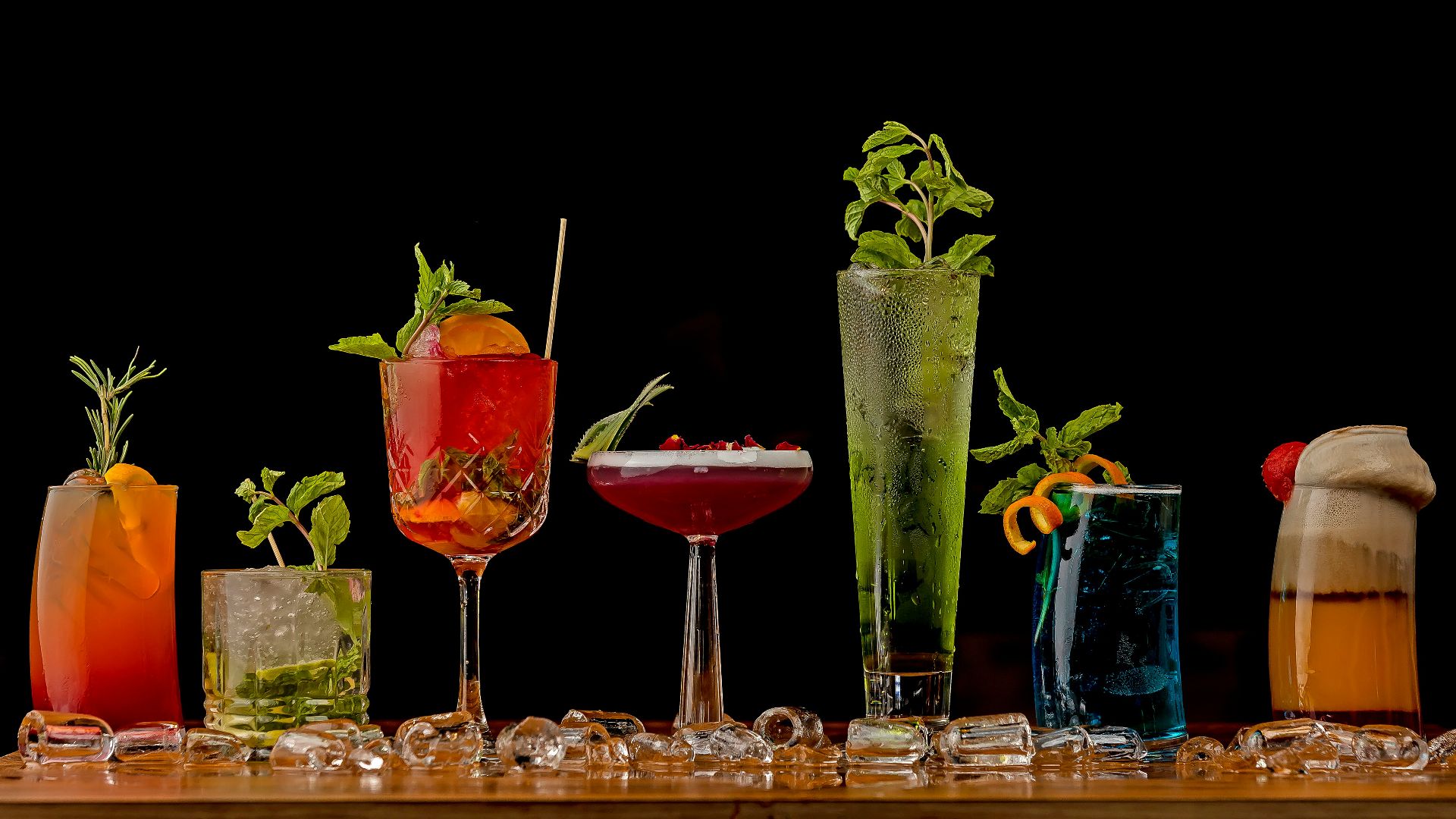 a table topped with lots of different types of drinks
