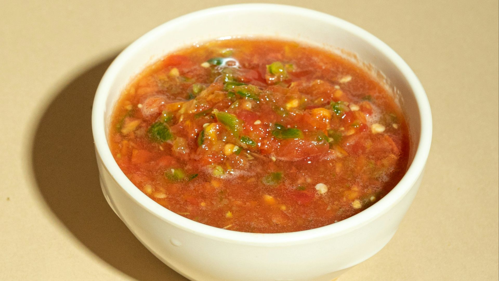 A bowl of soup is sitting on a table