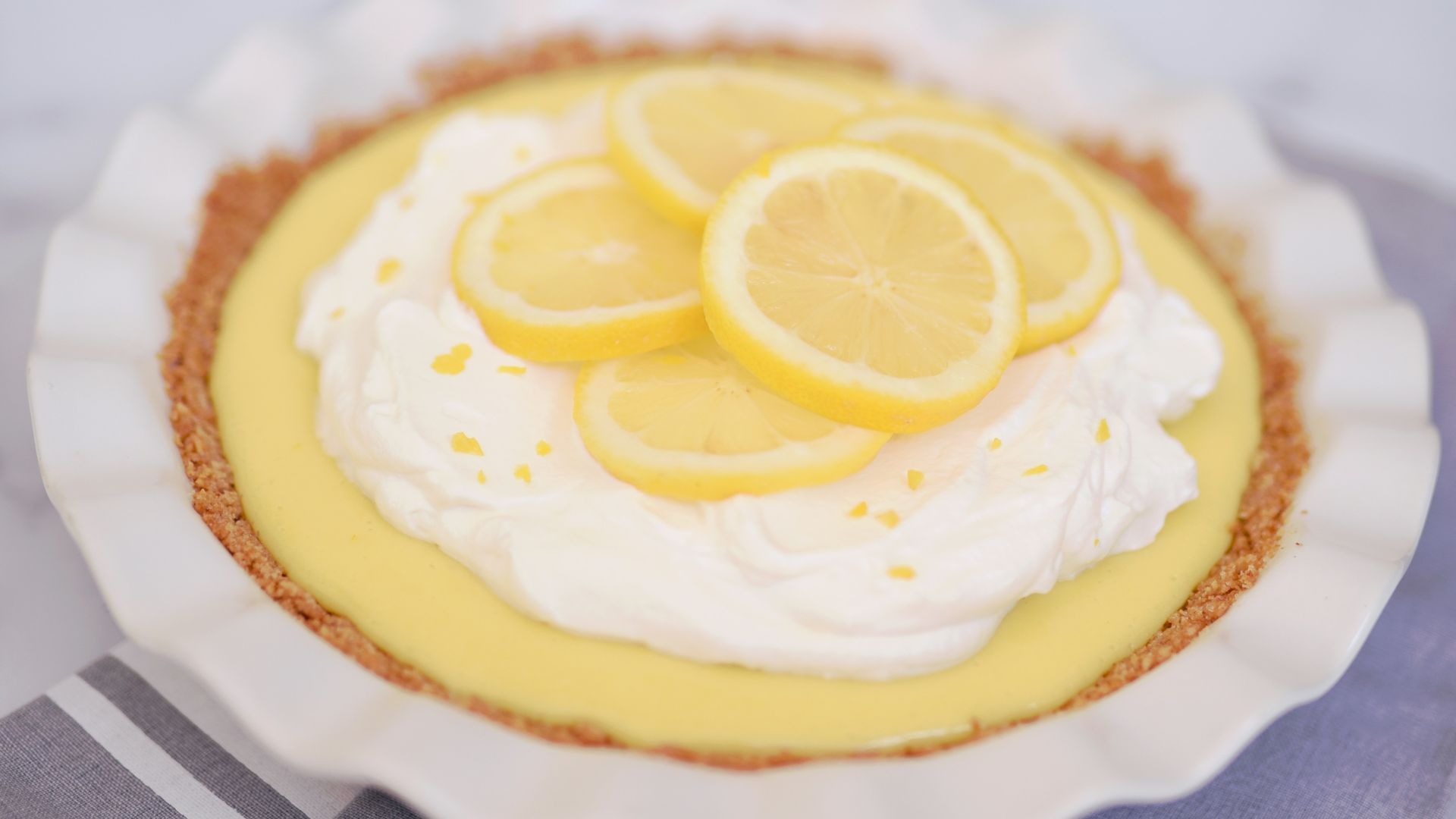 yellow and white cupcake on white and blue checkered textile