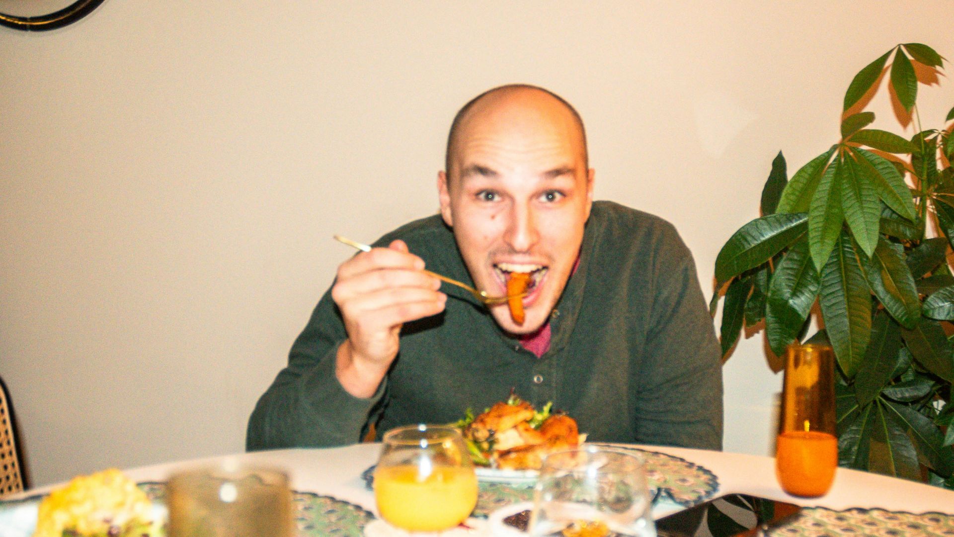 a man sitting at a table with a plate of food in front of him