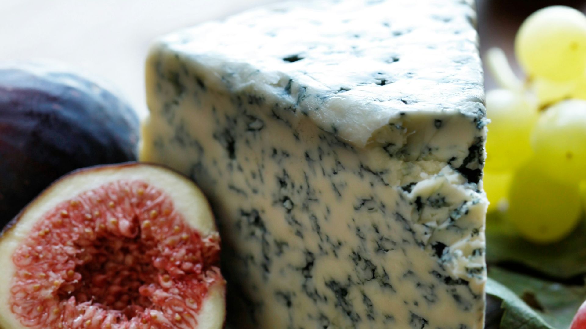 fruits and cheese on wooden surface