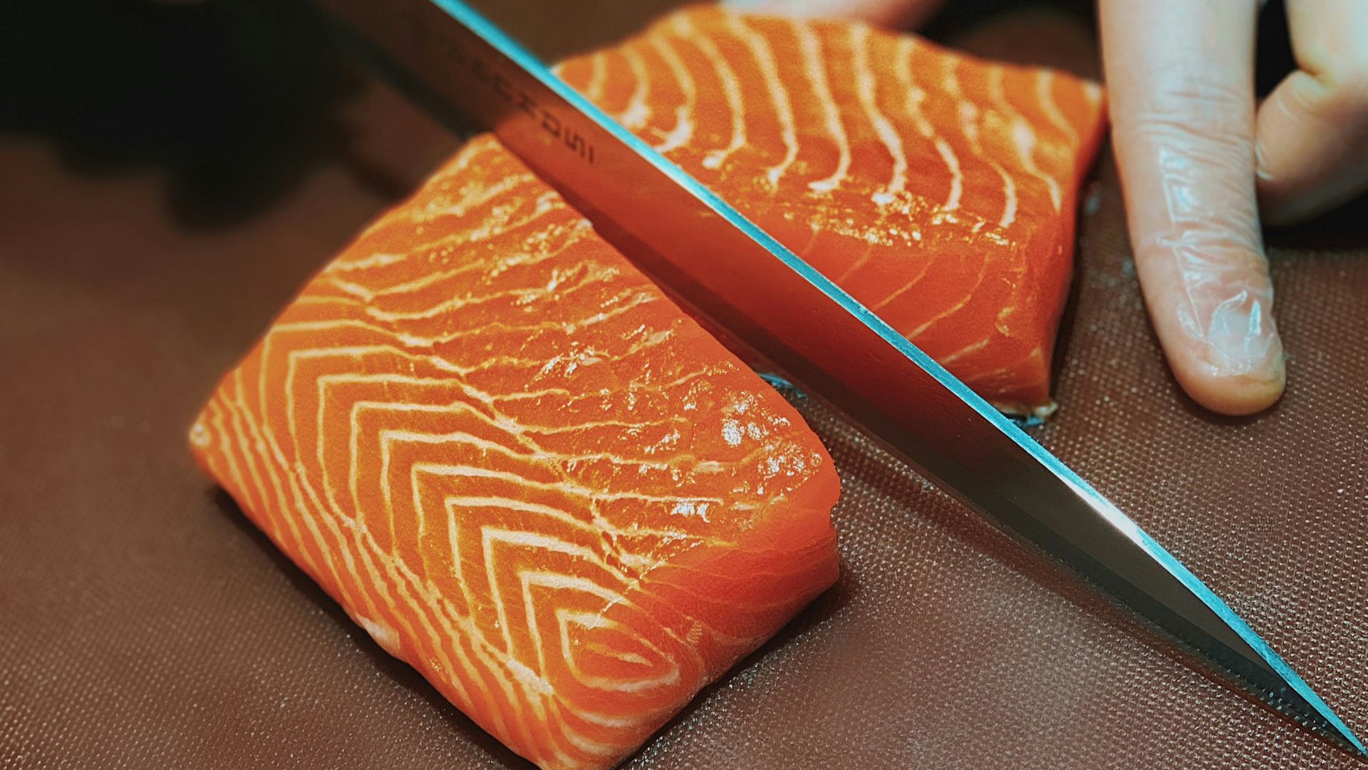 person holding black pencil and brown leather case