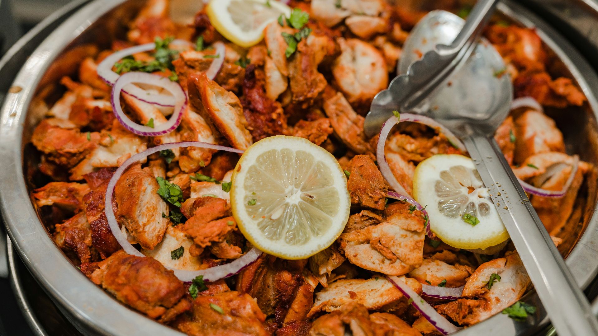 a plate of food with shrimp, lemons, and onions