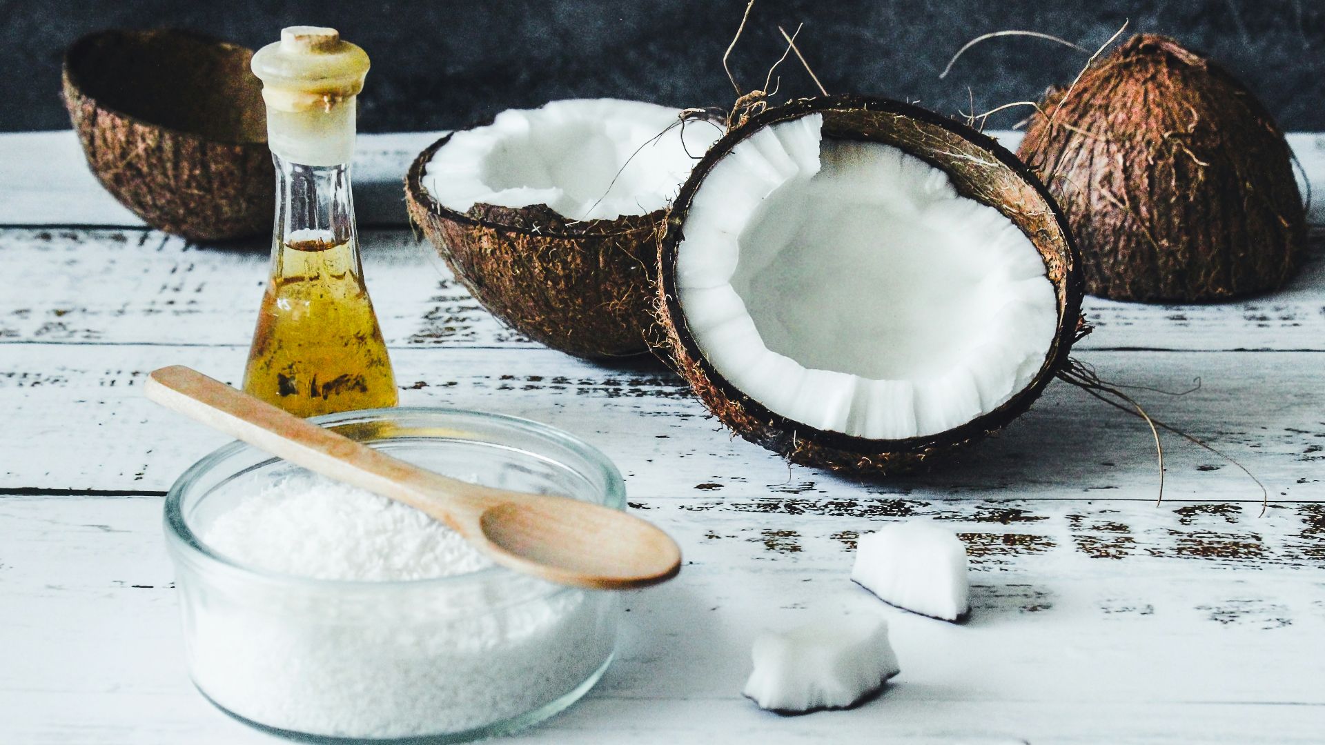 white powder in clear glass jar beside brown wooden spoon