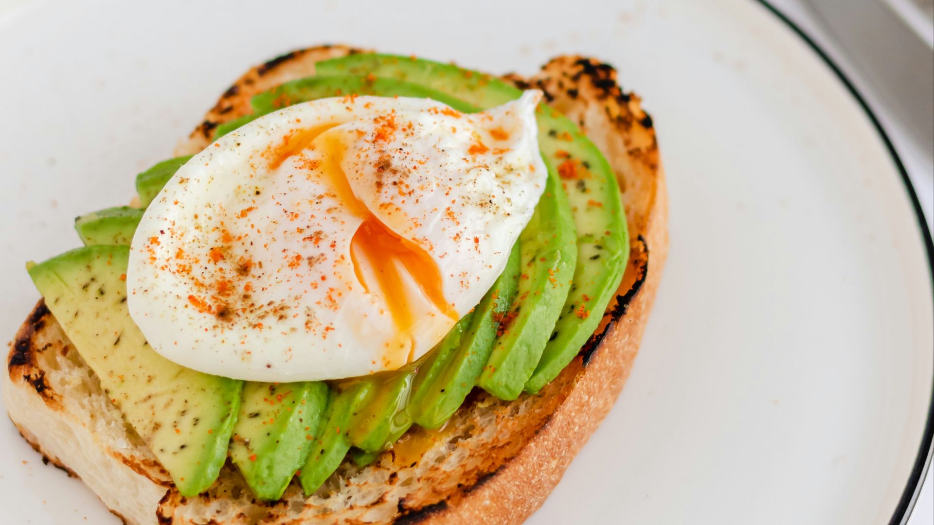 a sandwich with an egg and asparagus on it