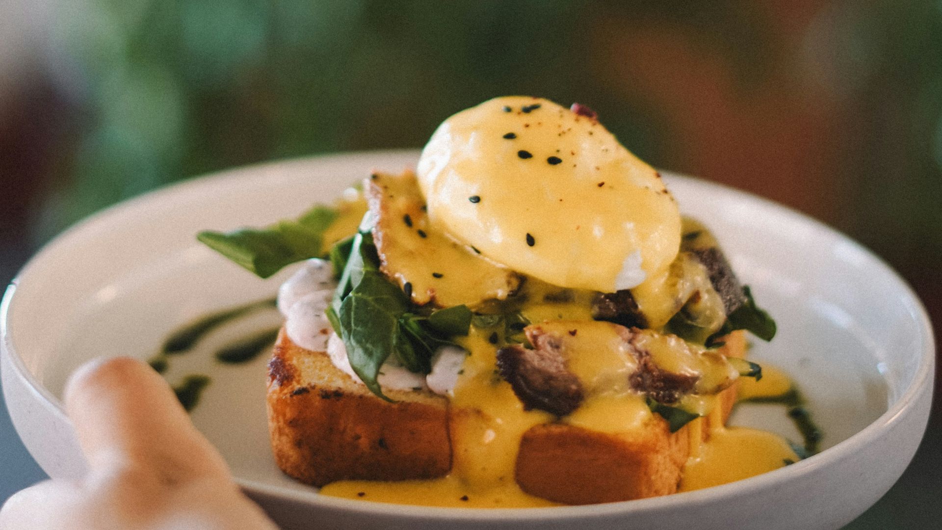 A person holding a bowl of food in their hand
