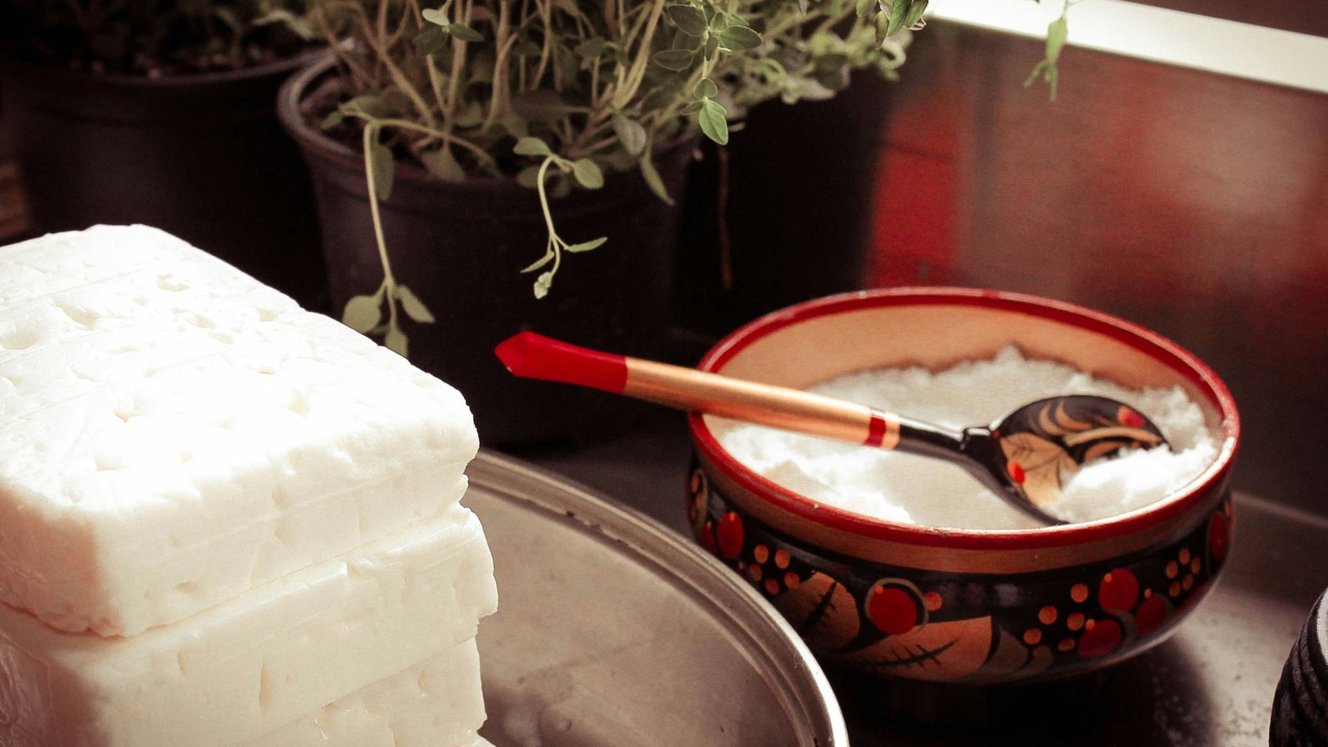 red ceramic bowl on gray spoon
