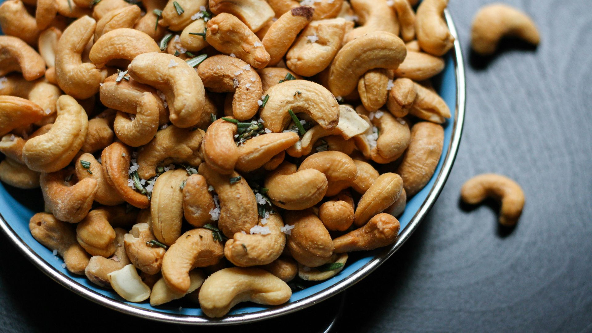 cashew nut lot on blue ceramic bowl