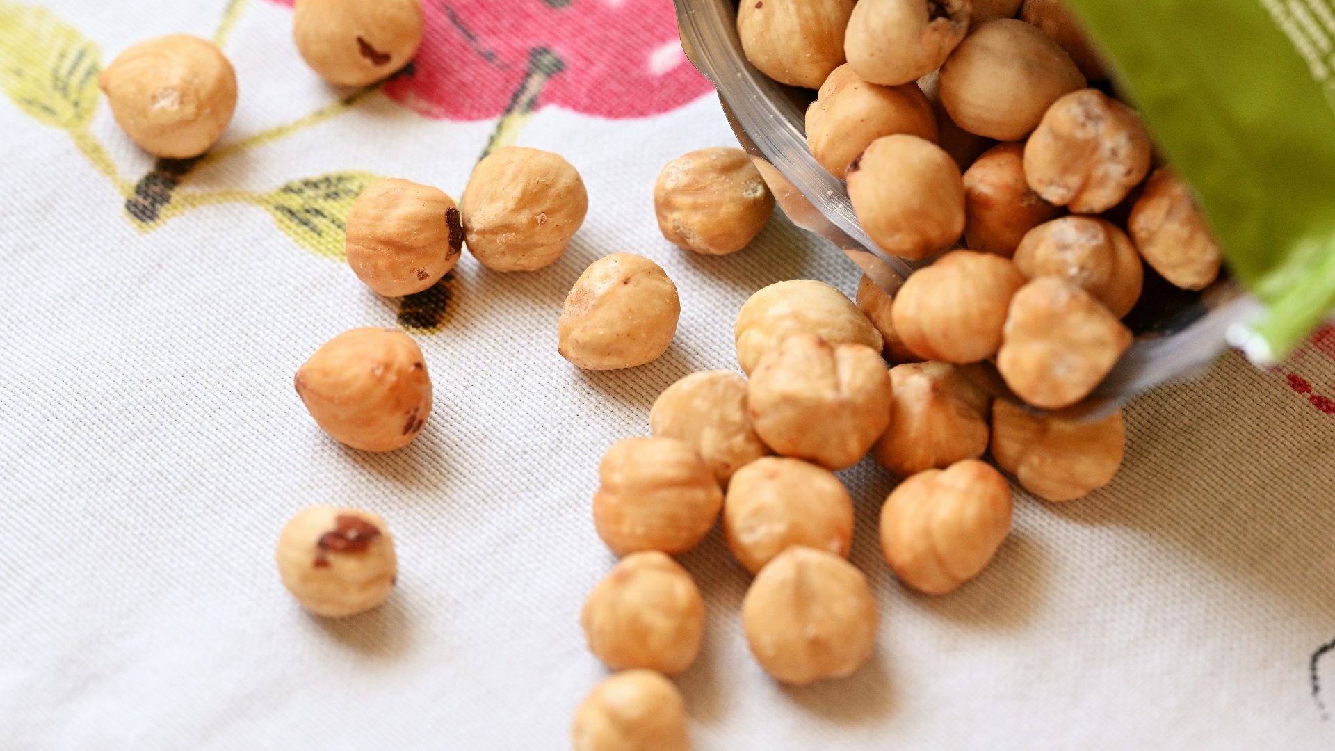 a bowl filled with nuts sitting on top of a table