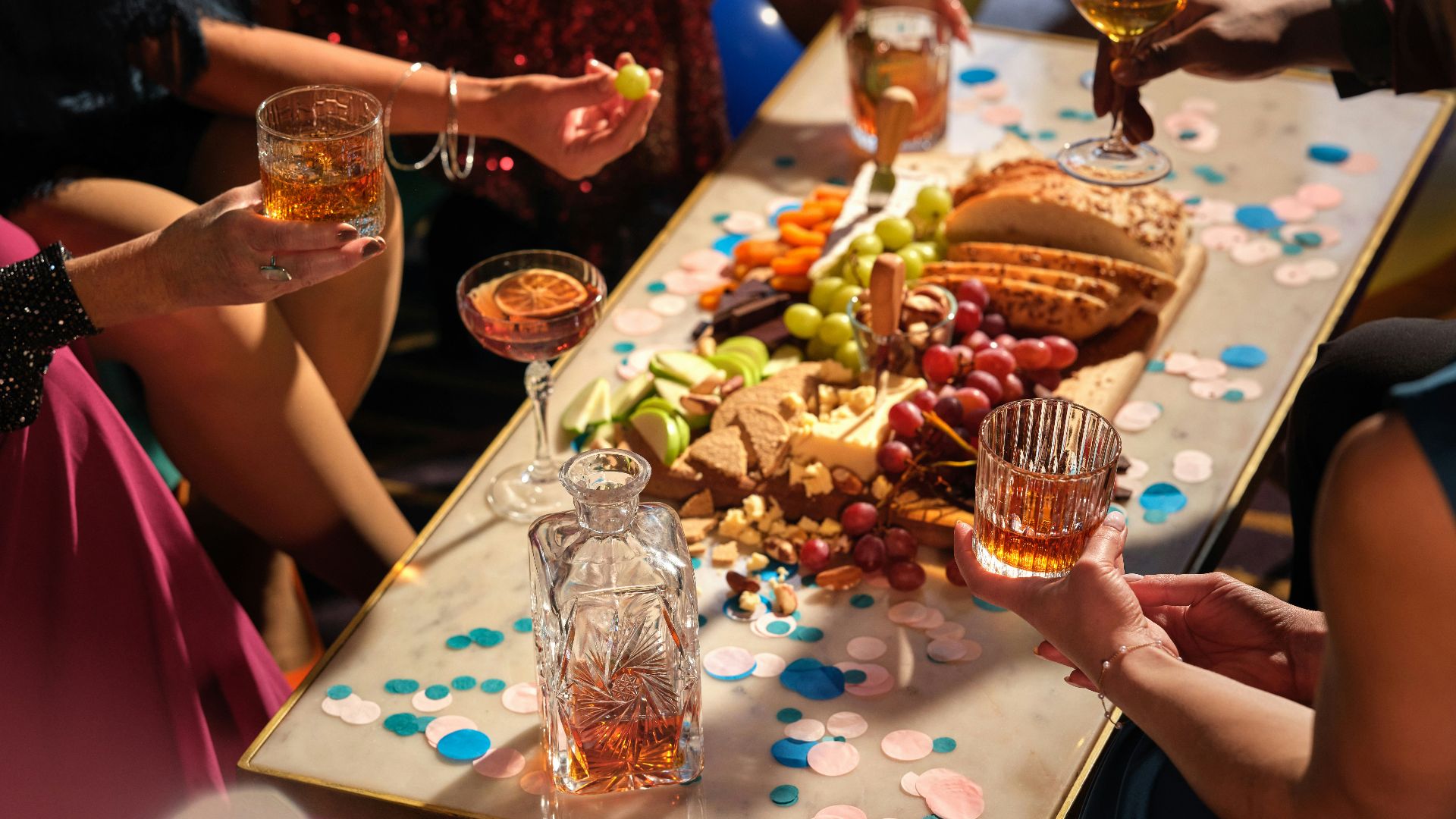 a group of people sitting around a table with food and drinks