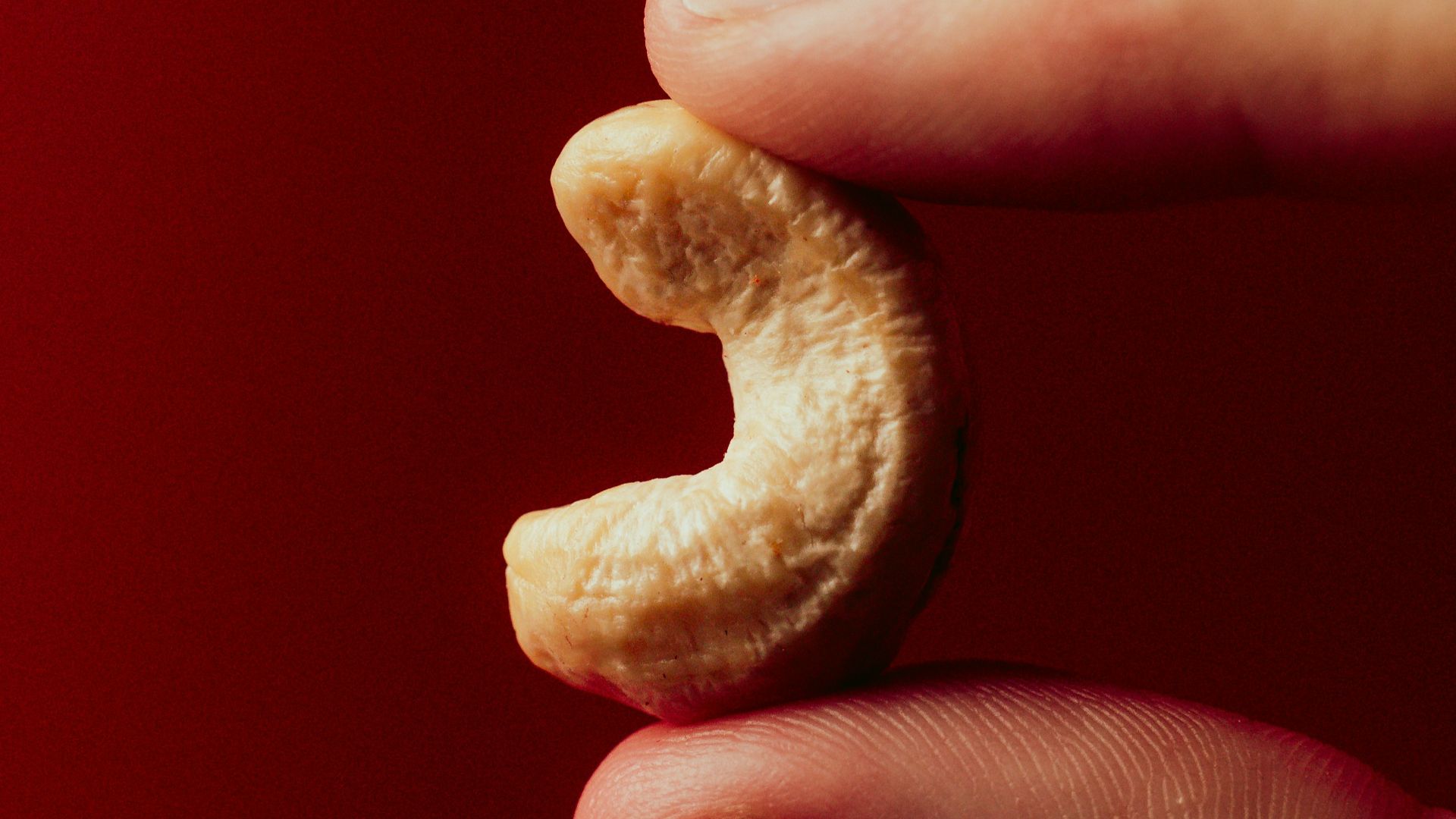 A person holding a half eaten banana in their hand