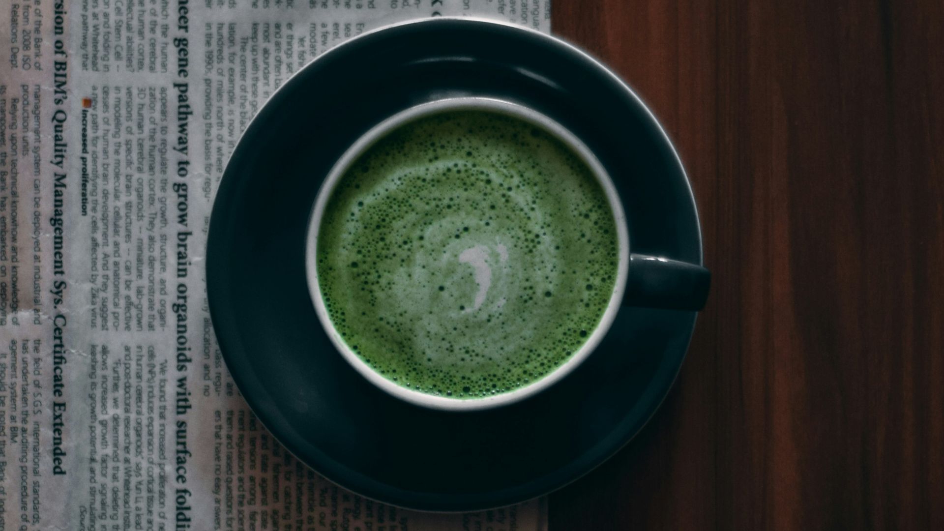green ceramic round plate on brown wooden table