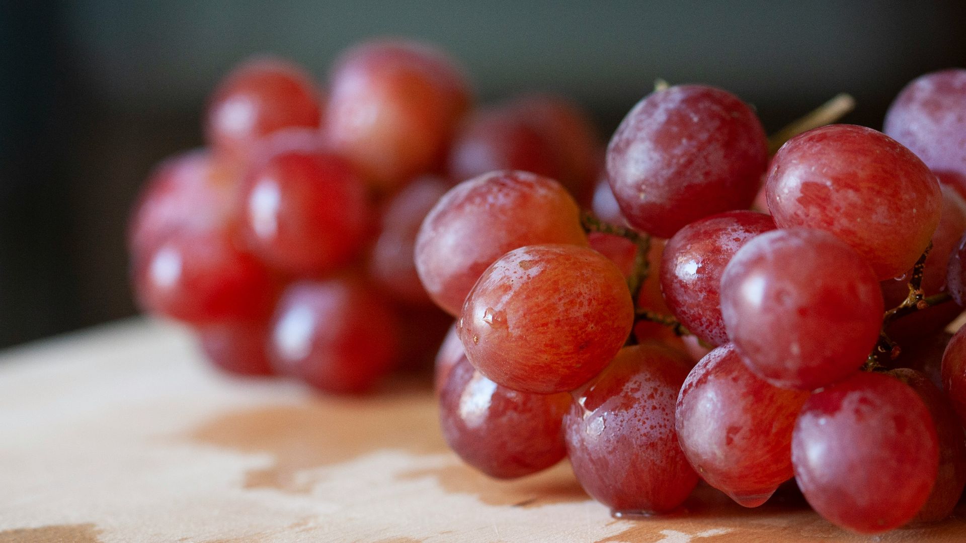 red round fruits on brown wooden table