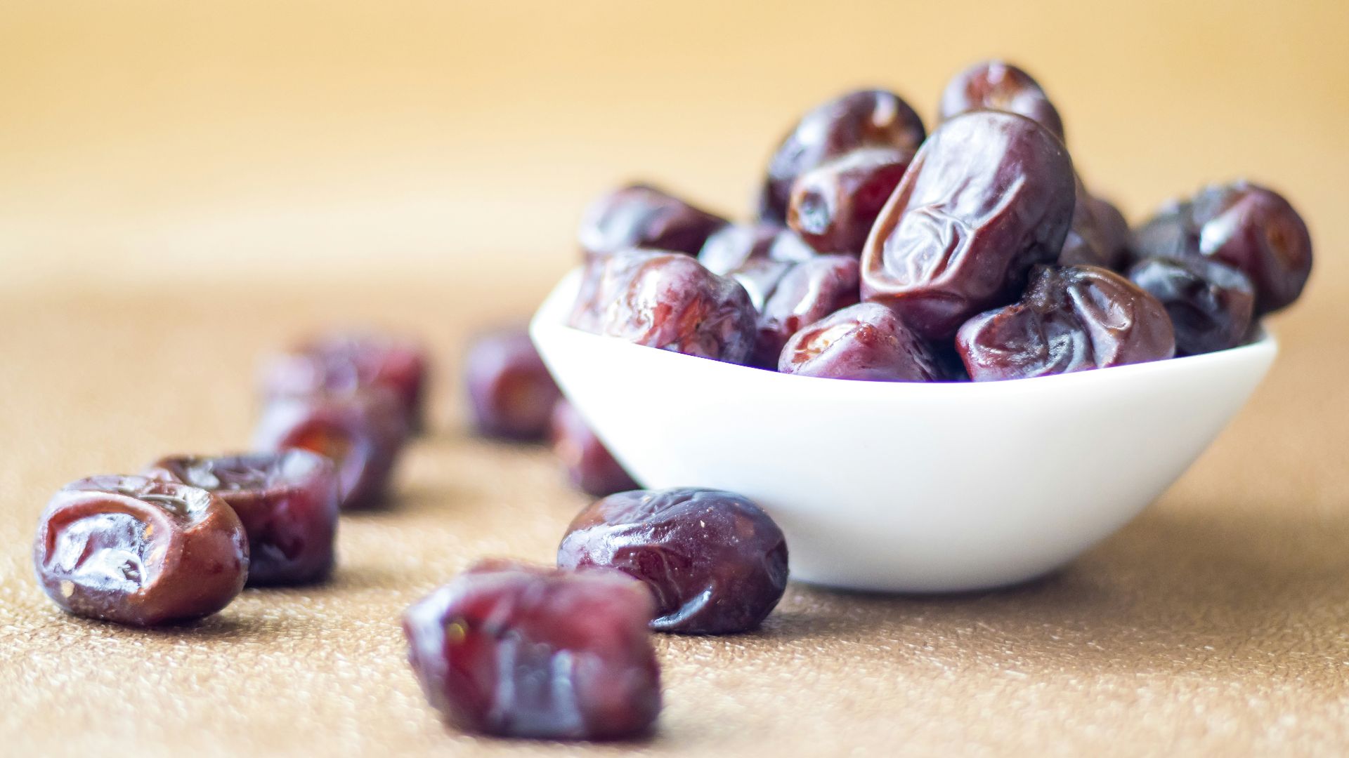 brown round fruit on white ceramic bowl
