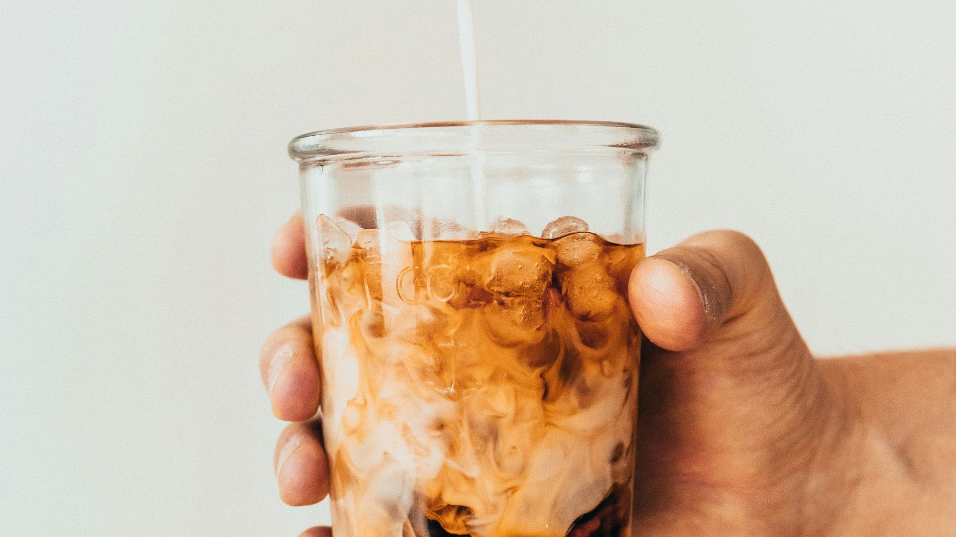 clear drinking glass with brown liquid