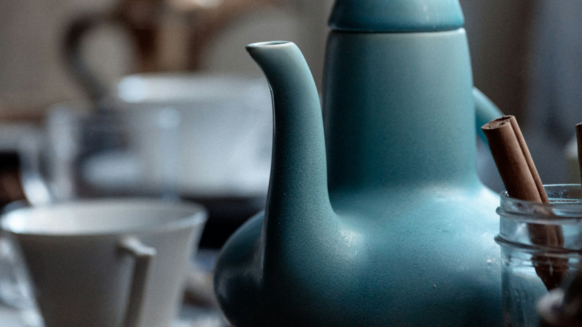 a blue teapot sitting on top of a table