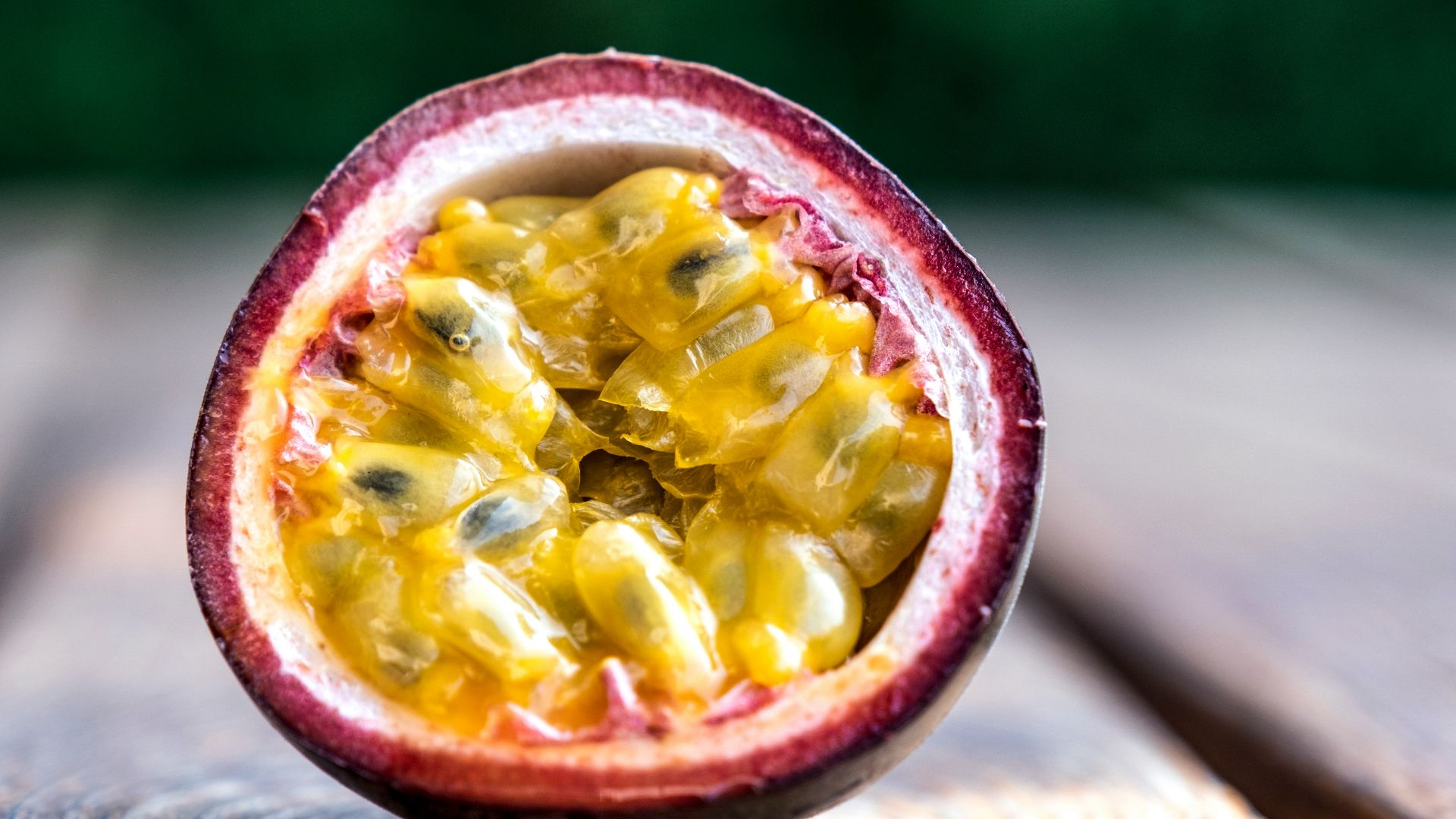 red and yellow round fruit on brown wooden table