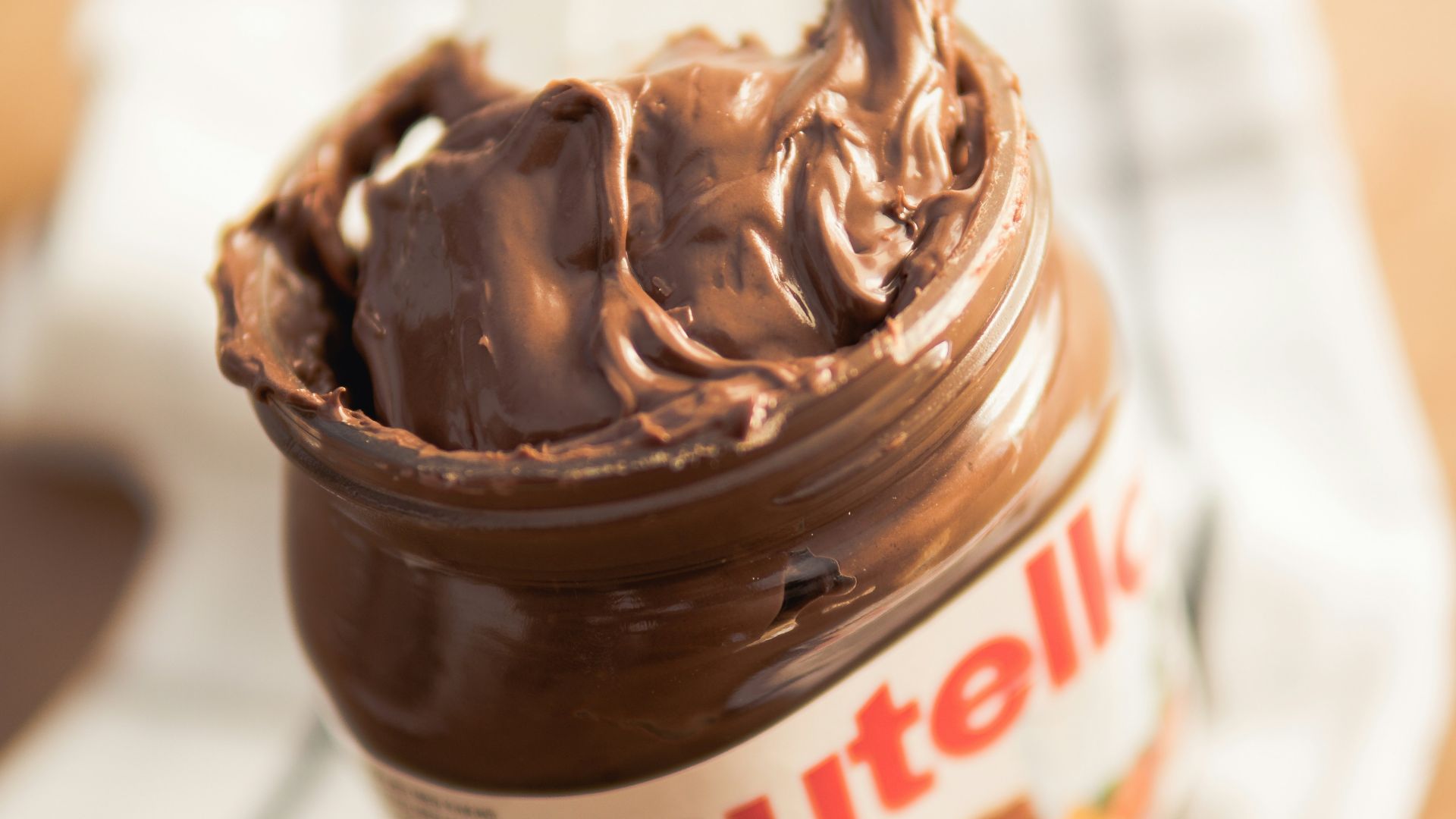 Nutella plastic container on white textile