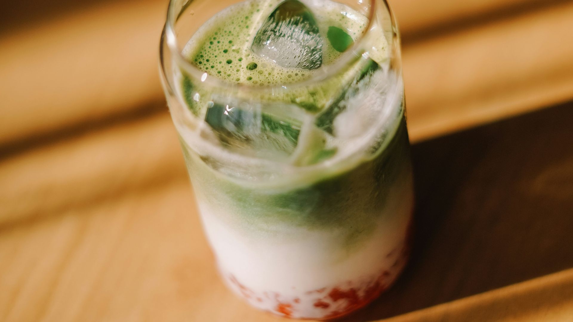 Iced matcha latte with strawberries and cream.