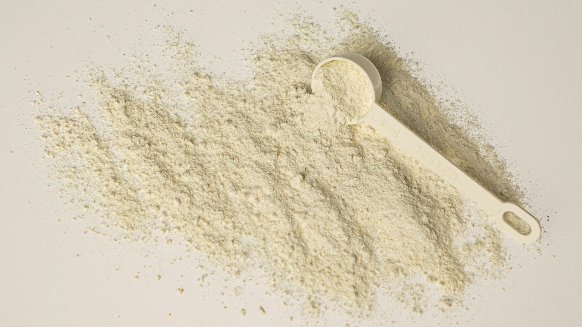 a scoop of powder and a scoop of powder on a white background