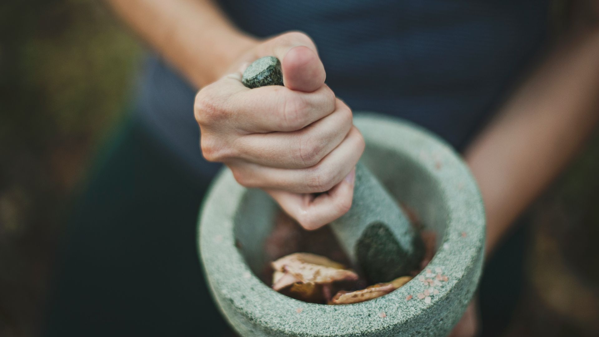 person grinding on mortar and pestle