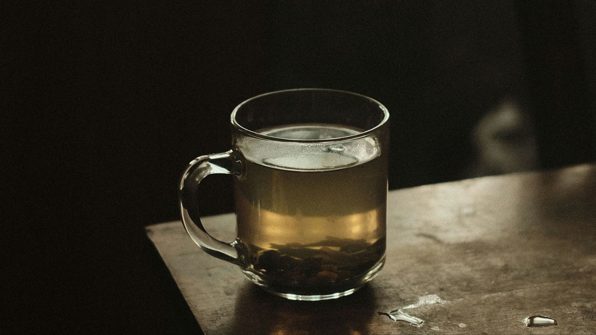 clear glass mug with brown liquid