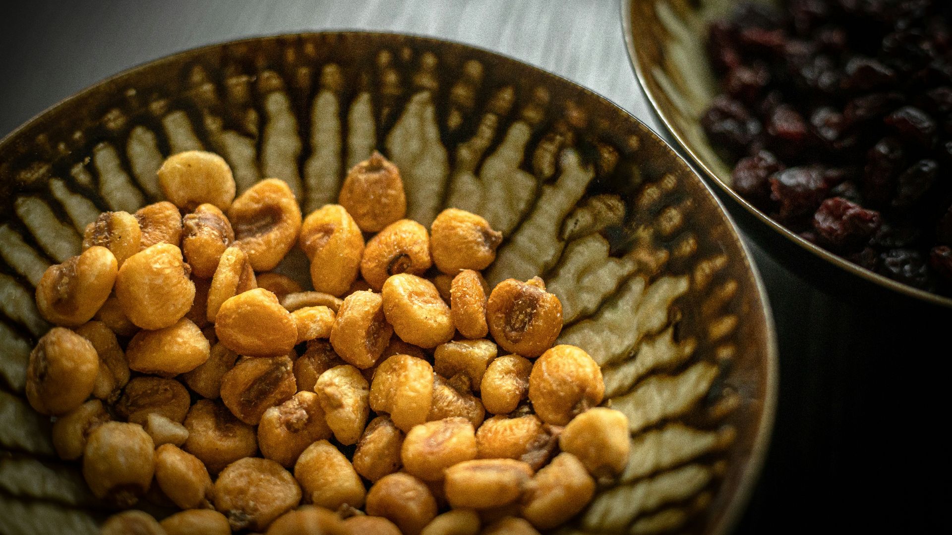 brown peanuts on black ceramic bowl