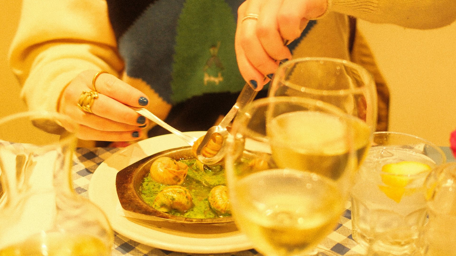 a woman sitting at a table with a plate of food