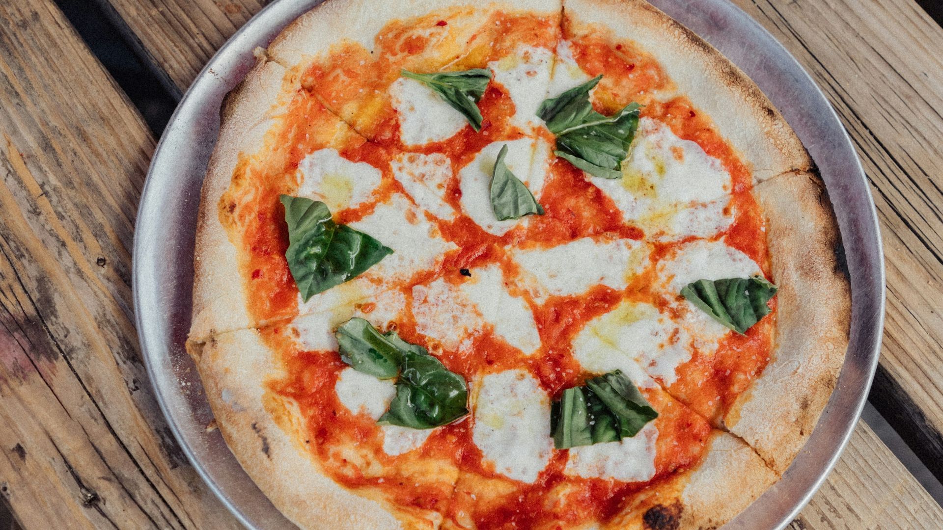 pizza on brown wooden table