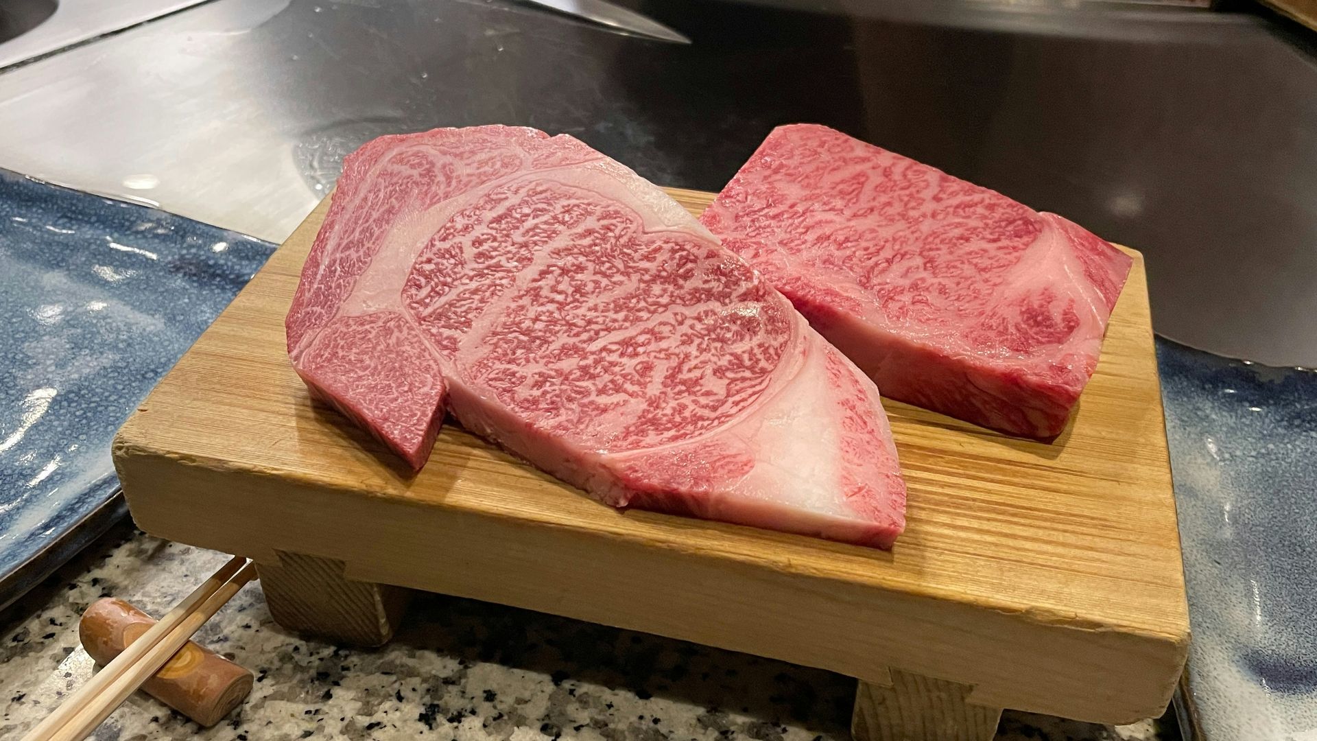 a couple of pieces of raw meat on a cutting board